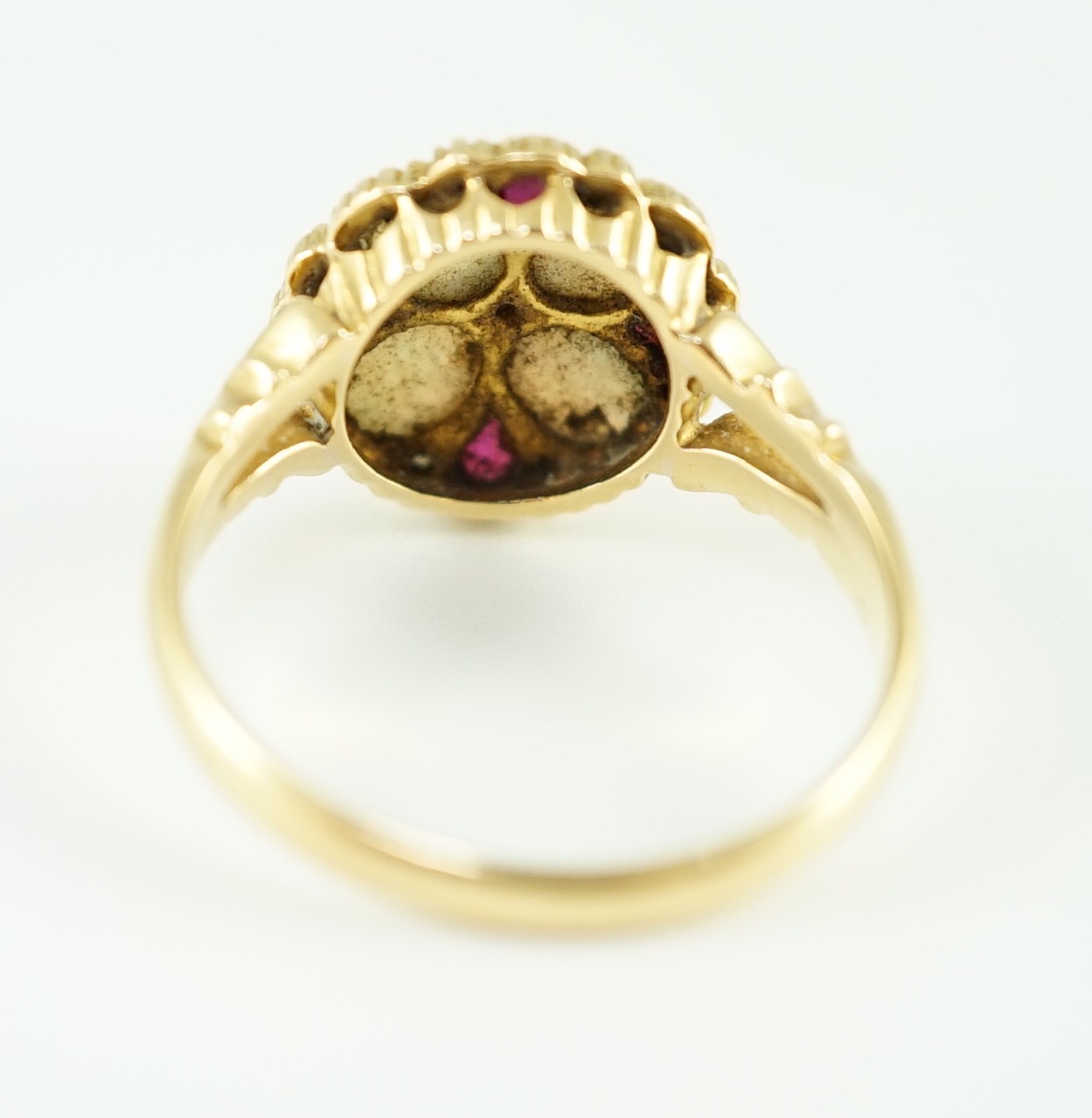 An Edwardian 18ct gold, ruby, white opal and diamond set circular cluster dress ring